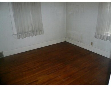 Bedroom. Note the hard wood flooring