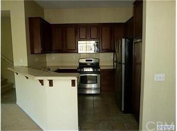 Open kitchen with breakfast bar, stainless steel a