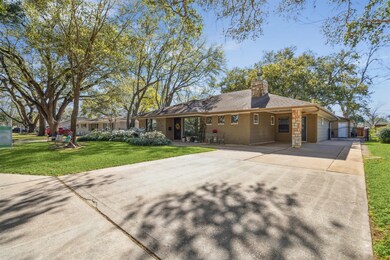 Double wide driveway extends to gated back patio.