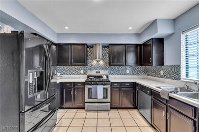 Kitchen with light tile patterned floors, stainles