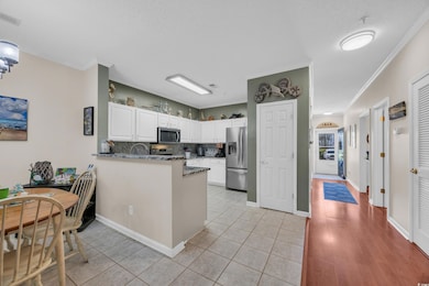 Kitchen featuring crown molding, visible vents, wh