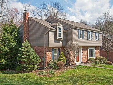 Beautiful mature landscaping sculpt this Colonial 