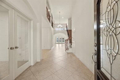 Elegant front entry with tile flooring, high ceili