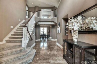 Impressive foyer with two story ceilings and skyli