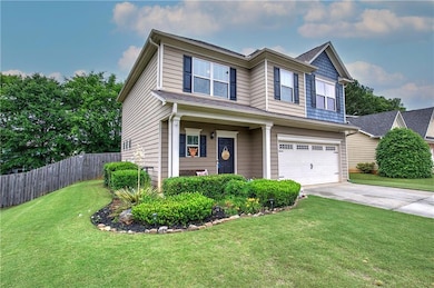 View of front of property with a garage and concrete driveway