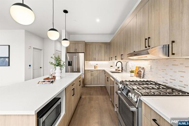 Gourmet Kitchen is Equipped with Top-Tier Appliances and Sleek Cabinetry