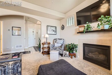 Living area featuring tile patterned floors, arche