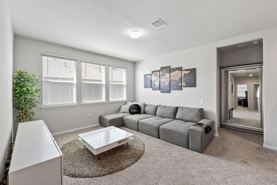 Carpeted living room featuring baseboards