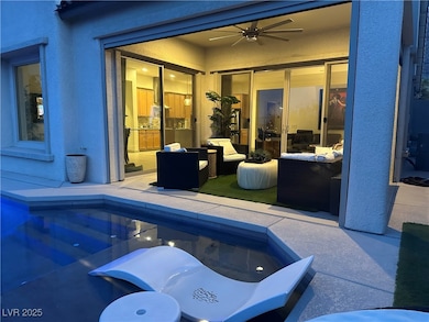 View of patio with ceiling fan, an outdoor pool, a