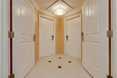 Foyer featuring ornamental molding, baseboards, an