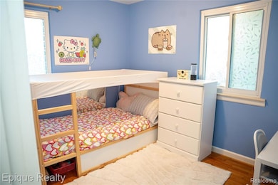 Bedroom featuring baseboards and wood finished floors
