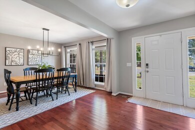 Formal dining room with updated light fixture and ample natural light