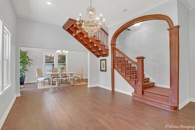 Living area features pretty arch, gorgeous chandel