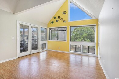 Empty room featuring high vaulted ceiling, wood fi