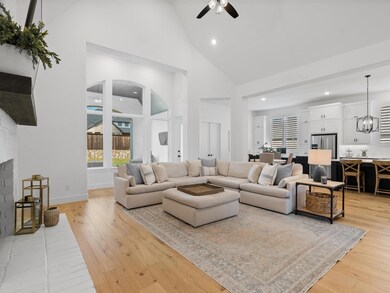 Living room with a painted brick fireplace, oak ha