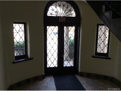 Note the arched windows and scrolled ironwork in t