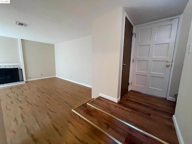 Unfurnished living room with baseboards and dark wood finished floors