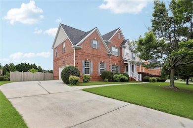 View of front facade featuring brick siding, a garage, and concrete driveway