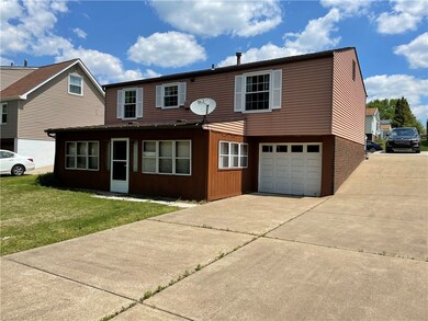 Rear of home. Sunroom has been added and 1 car int