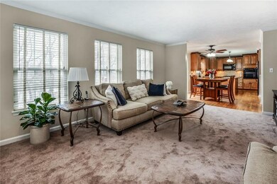 Family room is open to the kitchen and features just-installed carpet and fresh paint.