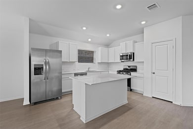 Kitchen with stainless steel appliances, backspla