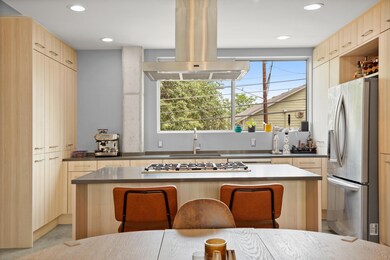 Kitchen with island exhaust hood, appliances with
