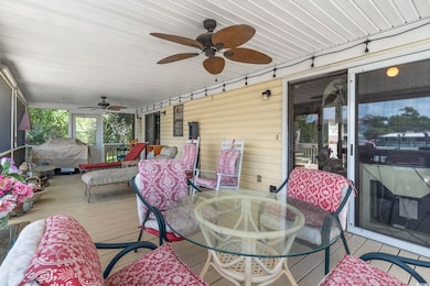 Wooden deck featuring ceiling fan and outdoor dining area