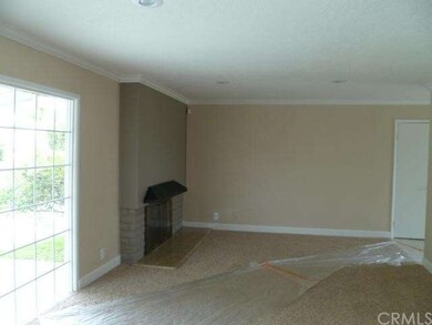 LIVING ROOM WITH VIEW OF PATIO AND REAR YARD