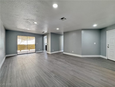 Unfurnished living room with a textured ceiling, b