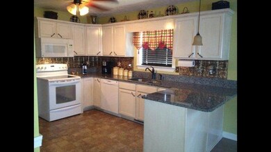 ALL APPLIANCES TO STAY IN THIS AWESOME KITCHEN WITH NEW GRANITE COUNTERTOPS. UTILITY ROOM IS OFF FROM KITCHEN AND OFFERS LOTS OF EXTRA STORAGE SPACE.