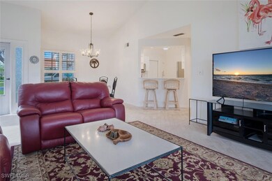 Living room featuring a chandelier, vaulted ceilin