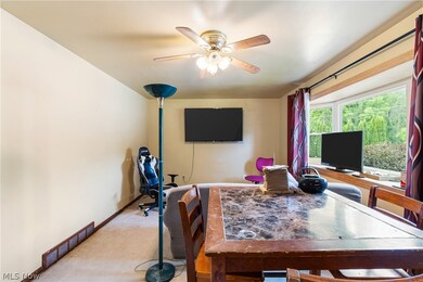 Carpeted office space featuring ceiling fan