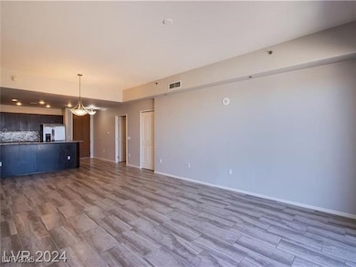 Unfurnished living room featuring wood finished fl