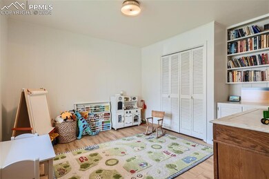 Rec room with built in shelves and light hardwood 