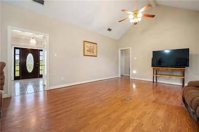 Unfurnished living room with light wood finished floors, high vaulted ceiling, ceiling fan, and beamed ceiling
