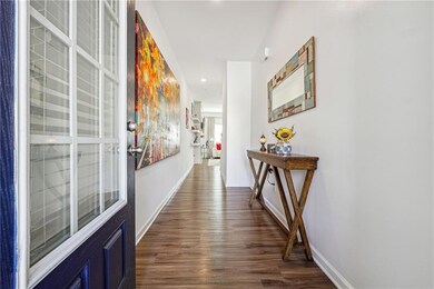 Hallway with recessed lighting, baseboards, and da