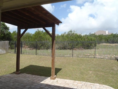 Fenced backyard with a patio
