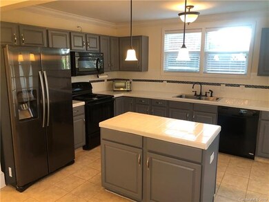 Spacious kitchen with tile back splash and island
