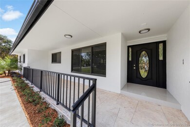 PATIO W/ RAILINGS, STAMPED CONCRETE & IMPACT WINDO