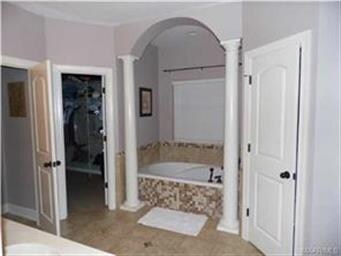 Beautiful tiled garden tub in the master bath