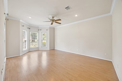 Primary suite with bay window, crown molding, & re
