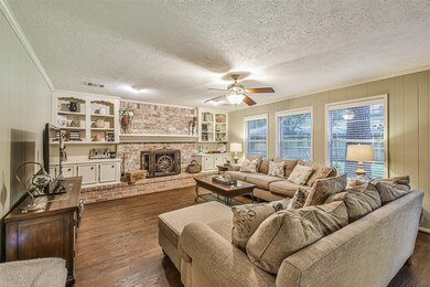 Spacious open living room with wall of windows and stunning fireplace.  Recently painted in neutral colors.