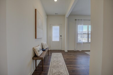 Entryway with baseboards and dark wood finished fl