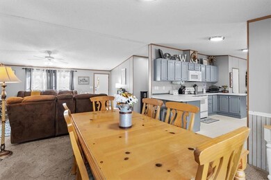 Dining space with ceiling fan, ornamental molding,
