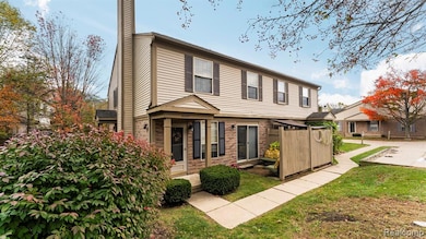Colonial house with a chimney and brick siding