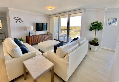 Living room with a textured ceiling and crown mold