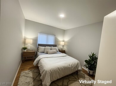 Bedroom with baseboards and wood finished floors