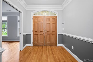 Foyer with light wood-style flooring, ornamental m