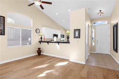 Foyer entrance with recessed lighting, light wood-type flooring, a ceiling fan, and high vaulted ceiling