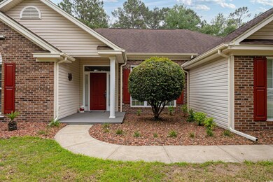 Doorway to property with brick siding and a shingl